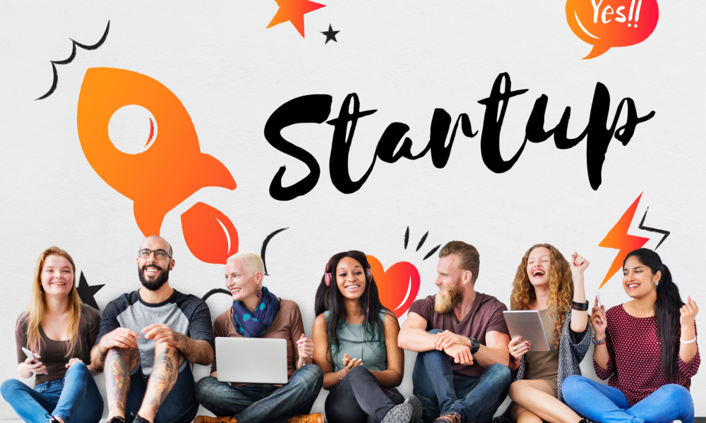 startup kültürünü temsil eden genç ve çeşitli ekip, roket illüstrasyonu ve “Startup” yazısı önünde birlikte çalışan girişimciler, yenilikçilik ve ekip ruhunu anlatan görsel